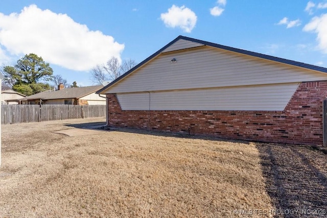 view of side of property with a yard