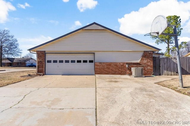 view of home's exterior featuring a garage and central AC