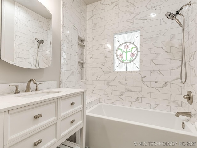 bathroom with vanity and tiled shower / bath