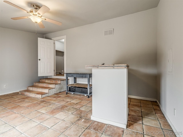 kitchen featuring ceiling fan and light tile patterned floors