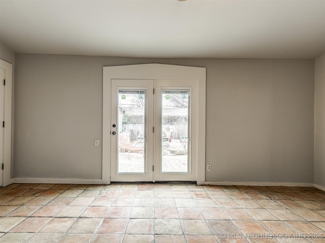 doorway to outside with light tile patterned floors