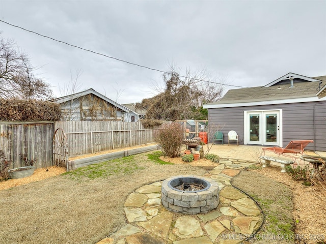 view of yard with french doors, a patio, and an outdoor fire pit