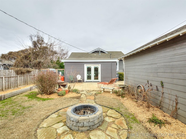 view of patio with french doors and a fire pit