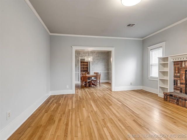 unfurnished living room with ornamental molding and light wood-type flooring