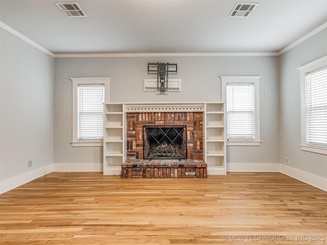 unfurnished living room with crown molding, a fireplace, and light hardwood / wood-style floors