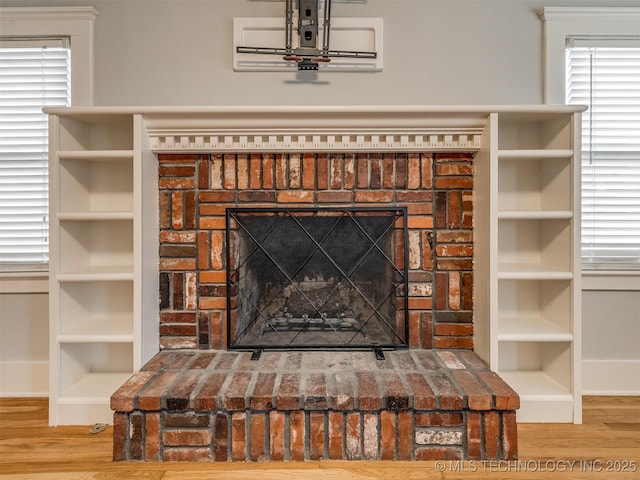 room details with hardwood / wood-style flooring and a fireplace