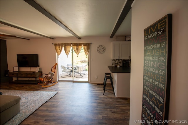 living room with beam ceiling and dark hardwood / wood-style flooring