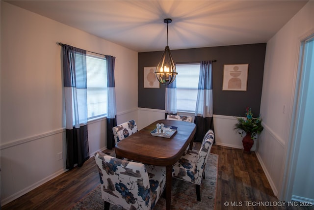 dining room featuring dark hardwood / wood-style floors and a chandelier