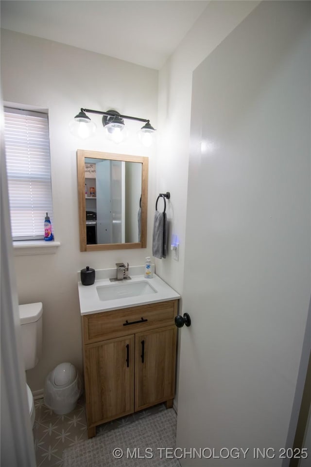 bathroom featuring vanity and toilet