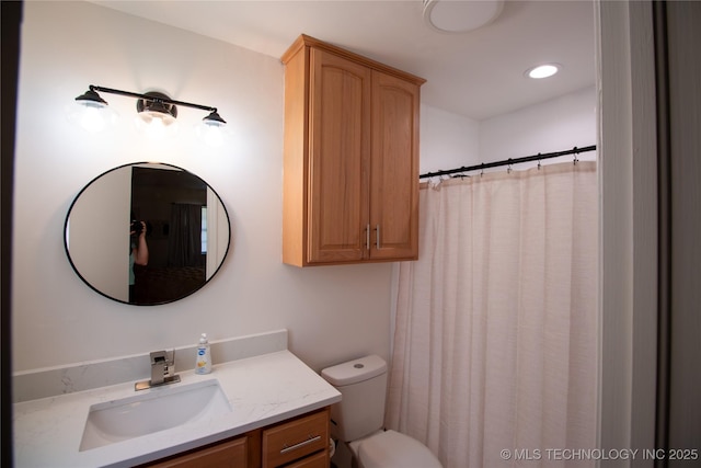 bathroom with vanity, toilet, and a shower with shower curtain