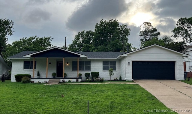 ranch-style house with a garage, a front yard, and covered porch