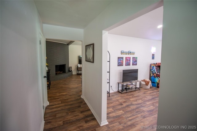 hallway with dark hardwood / wood-style flooring