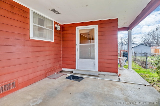 entrance to property featuring a patio area