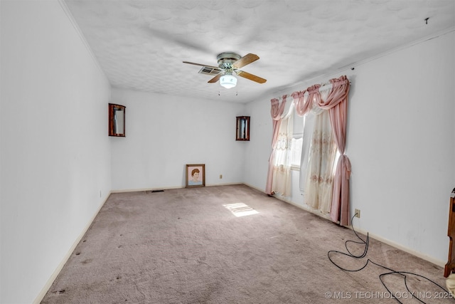 spare room with light carpet, a textured ceiling, and ceiling fan