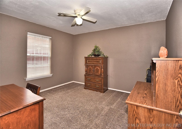 office featuring ceiling fan, a textured ceiling, and dark colored carpet