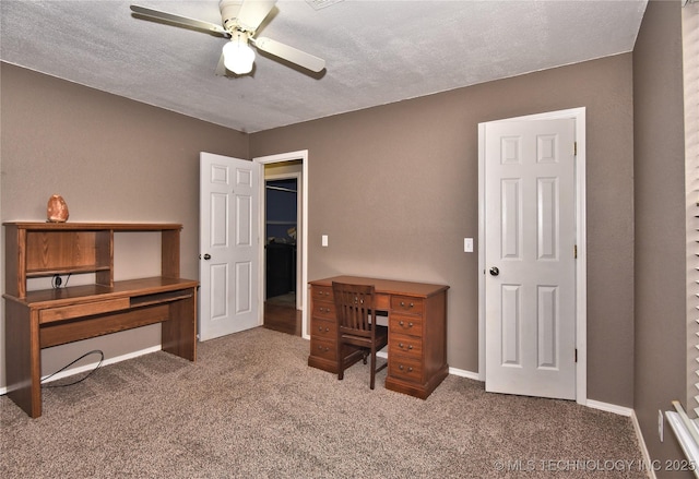 home office with a textured ceiling, ceiling fan, and carpet flooring