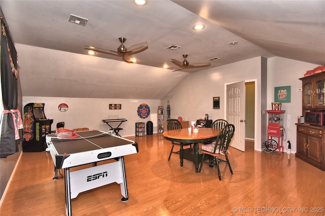 game room featuring hardwood / wood-style flooring, lofted ceiling, and ceiling fan