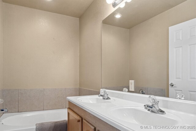 bathroom featuring vanity and a bathing tub