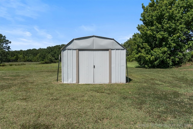 view of outbuilding featuring a lawn