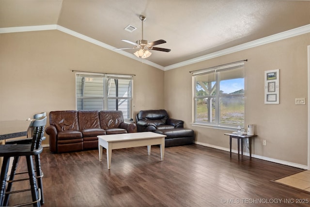 living room featuring vaulted ceiling, dark hardwood / wood-style floors, ceiling fan, and crown molding