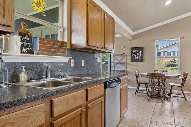 kitchen featuring dishwasher, lofted ceiling, sink, decorative backsplash, and light tile patterned floors