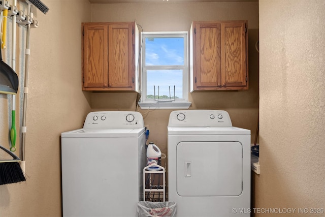 laundry room with cabinets and washer and dryer