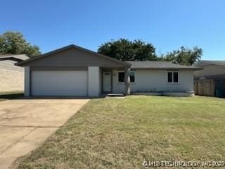 single story home with a garage and a front lawn