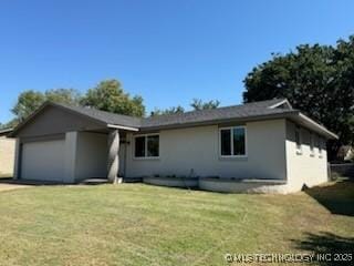 ranch-style home with a garage and a front lawn