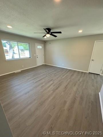 interior space featuring ceiling fan, hardwood / wood-style floors, and a textured ceiling