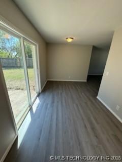 spare room with dark hardwood / wood-style flooring