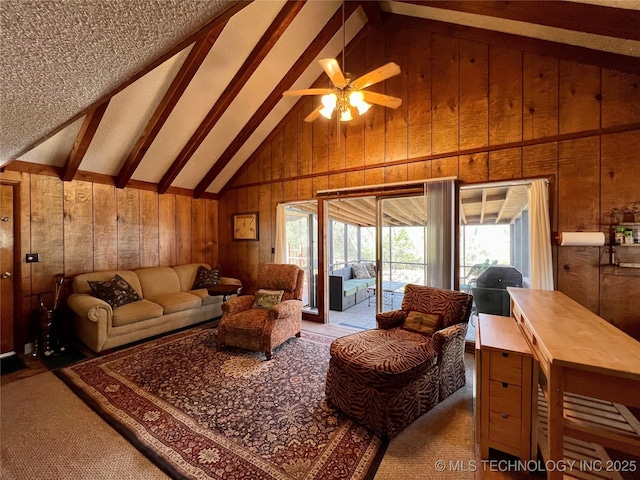 4 Canadian Dr, Burneyville, OK 73430 - living area featuring wooden walls, beam ceiling, ceiling fan, high vaulted ceiling, and carpet floors