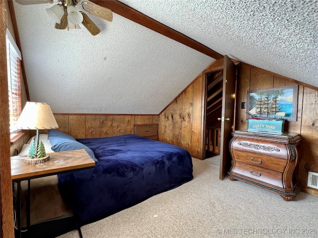 4 Canadian Dr, Burneyville, OK 73430 - carpeted bedroom featuring wood walls, a textured ceiling, and lofted ceiling