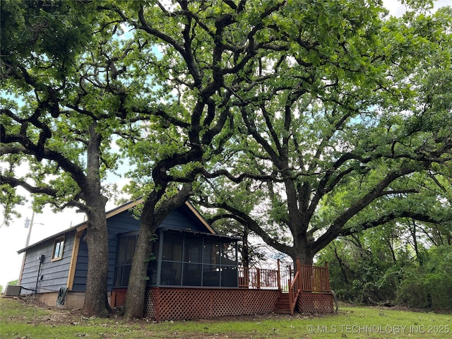 4 Canadian Dr, Burneyville, OK 73430 - view of property exterior featuring a sunroom, central AC unit, and a wooden deck