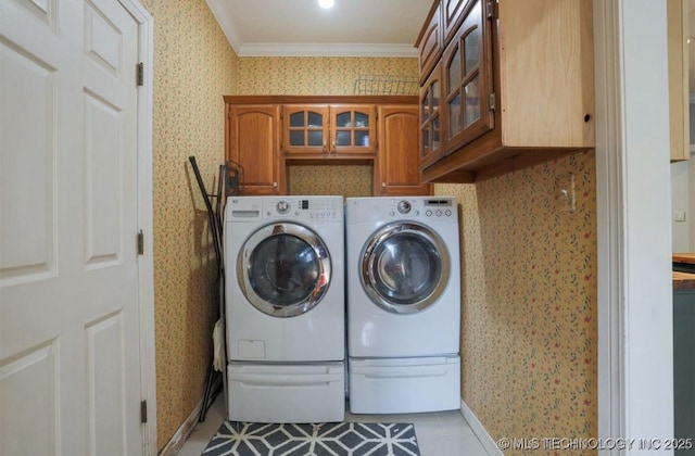 8918 S Lakewood Ave, Tulsa, OK 74137 - laundry room featuring wallpapered walls, cabinet space, washing machine and dryer, ornamental molding, and light tile patterned floors