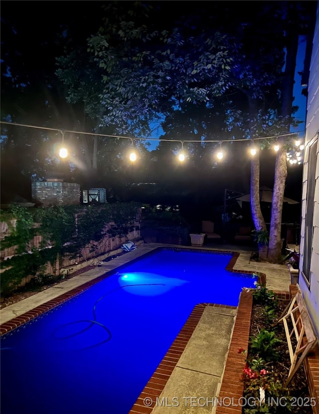 8918 S Lakewood Ave, Tulsa, OK 74137 - pool at night with an outdoor pool