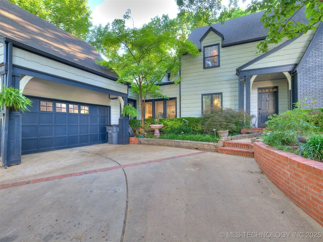 8918 S Lakewood Ave, Tulsa, OK 74137 - view of front of home with concrete driveway, a shingled roof, and an attached garage