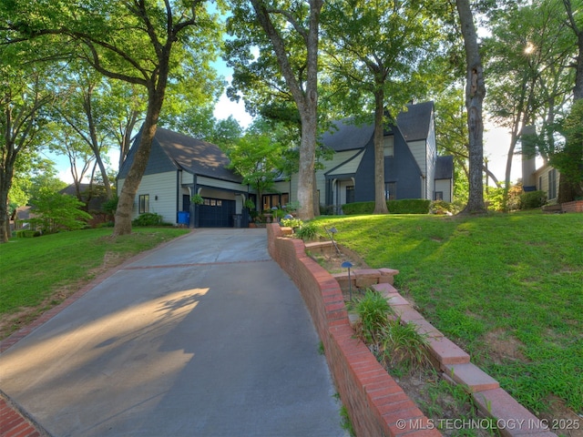 8918 S Lakewood Ave, Tulsa, OK 74137 - view of front of property with concrete driveway, a front lawn, and a garage