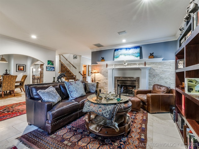 8918 S Lakewood Ave, Tulsa, OK 74137 - tiled living area featuring ornamental molding, stairway, arched walkways, a fireplace, and recessed lighting