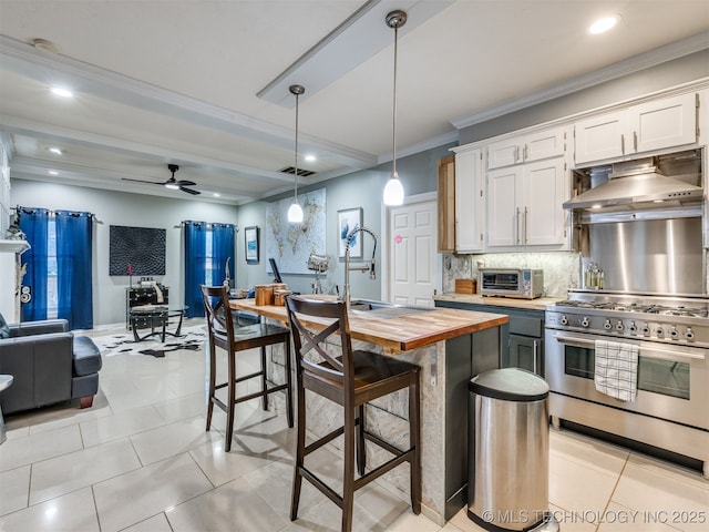 8918 S Lakewood Ave, Tulsa, OK 74137 - kitchen featuring high end stove, wooden counters, range hood, decorative backsplash, and ceiling fan