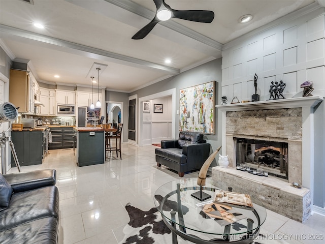 8918 S Lakewood Ave, Tulsa, OK 74137 - living area featuring crown molding, ceiling fan, a stone fireplace, and recessed lighting