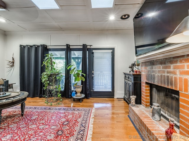 8918 S Lakewood Ave, Tulsa, OK 74137 - living area featuring a skylight, a brick fireplace, light wood-style flooring, and recessed lighting
