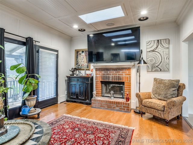 8918 S Lakewood Ave, Tulsa, OK 74137 - living room with a skylight, ornamental molding, healthy amount of natural light, wood finished floors, and a brick fireplace