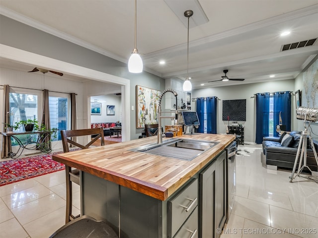 8918 S Lakewood Ave, Tulsa, OK 74137 - kitchen featuring wooden counters, a ceiling fan, open floor plan, light tile patterned floors, and crown molding