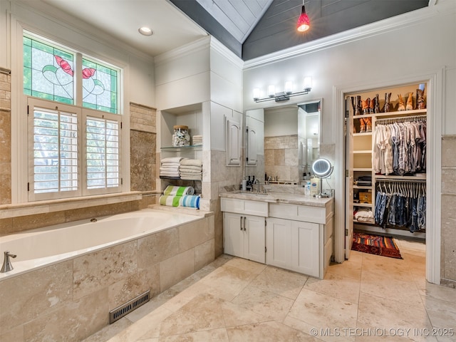 8918 S Lakewood Ave, Tulsa, OK 74137 - full bath featuring healthy amount of natural light, ornamental molding, vanity, a bath, and a spacious closet