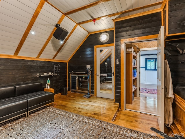 8918 S Lakewood Ave, Tulsa, OK 74137 - unfurnished living room featuring wood walls, hardwood / wood-style floors, and lofted ceiling