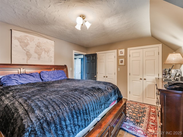 8918 S Lakewood Ave, Tulsa, OK 74137 - bedroom with multiple closets, light wood finished floors, and lofted ceiling
