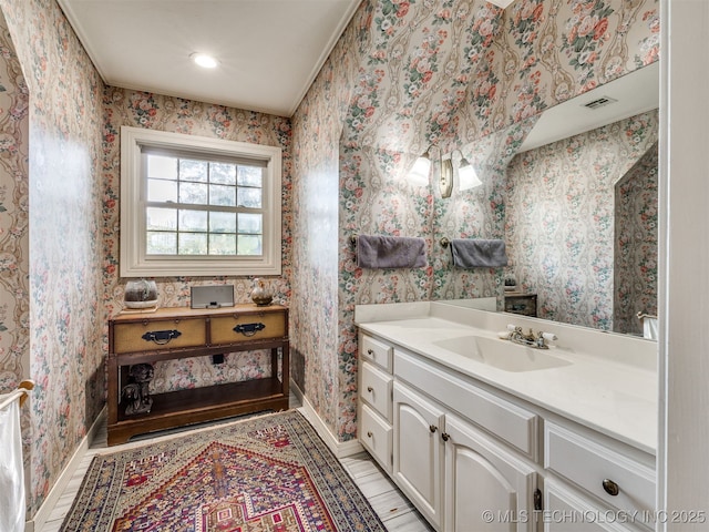 8918 S Lakewood Ave, Tulsa, OK 74137 - bathroom featuring vanity, wood finished floors, wallpapered walls, and recessed lighting