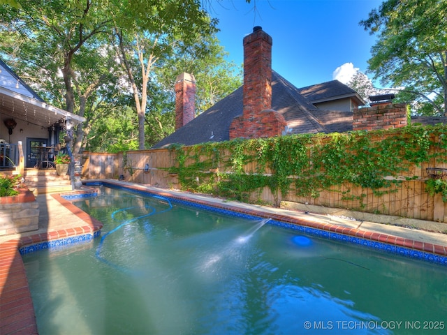 8918 S Lakewood Ave, Tulsa, OK 74137 - view of swimming pool with a fenced backyard