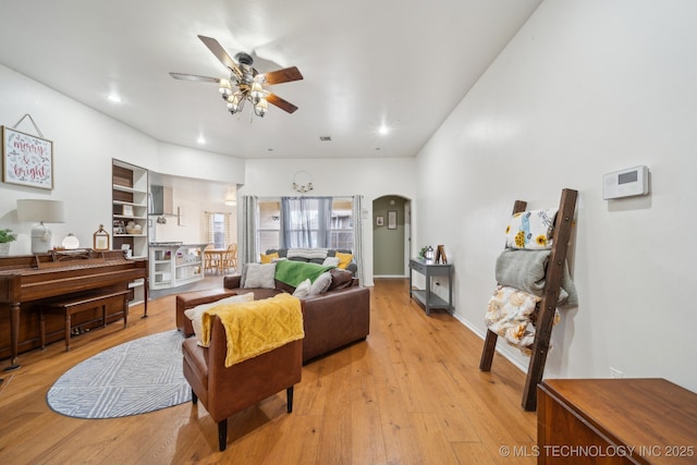 living room with ceiling fan and light wood-type flooring