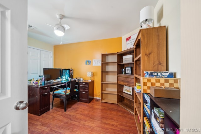 home office with dark hardwood / wood-style floors and ceiling fan